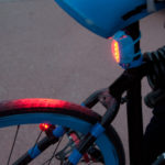 Red rear lights on a bicycle.